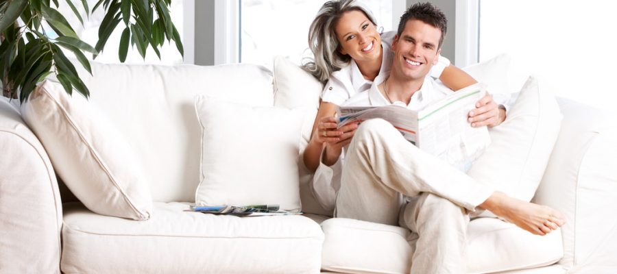 Young love couple reading magazine  in the comfortable apartment